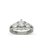 Claw Round and Pear Shaped Diamond Trilogy Ring Ring Pruden and Smith Engagement Ring with one fitted band  